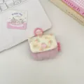 Close-up detail of pink quilted earphone pouch with floral corduroy flap and hook - Dusty Pink