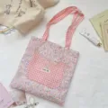 Floral fabric tote bag featuring a pink cat-shaped gingham pocket and matching straps - Cat Head Shoulder Bag