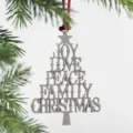 Detailed shot of a metallic Christmas tree ornament featuring stacked holiday words and red hanging cord. - Christmas Tree