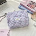 Macro view of a purple quilted plaid cosmetic bag featuring pink bows and a Surakku label - Purple Gingham Bow