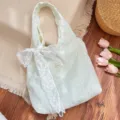 Detailed macro shot of white lace tote bag with floral embroidery and large bow decoration - Tote Bag With White Bow (6531) / Green