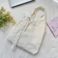 Macro view of cream white cherry blossom embroidered tote bag featuring lace bow detail - Tote Bag With White Bow (6531) / Apricot