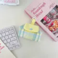 Vibrant plaid snap-button storage pouch for earphones and lipstick shown in detail - Blue Grid