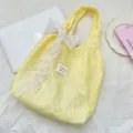 Sweet yellow floral gauze tote bag featuring a decorative white lace bow accent - Bag With White Lace Bow Decoration / Bright yellow