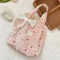 Close-up of pink striped tote bag with heart embroidery and large lace bow detail. - Heart Stripe with White Bow Style
