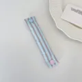 Dettaglio del cinturino fermacavi a righe macaron con bottone a pressione a cuore - Righe Cuore Arancione Caramello