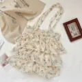 Elegante gestufte Rüschen-Schultertasche mit gelbem Tulpenprint aus strukturierter Spitze-Baumwolle - 裙摆单肩包