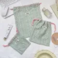 Detailed view of three light green floral embroidered drawstring storage pouches - Small (14x15) / Light Green