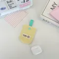 Detailed shot of yellow quilted earphone storage pouch with teal ribbon loop - Bright yellow