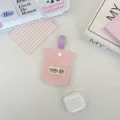 Close-up view of a pink quilted earphone storage pouch featuring a purple strap - Pink