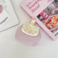 Floral quilted coin purse detail showing pink snap button and lavender fabric texture. - Dusty Pink