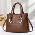 Elegant brown crocodile embossed handbag featuring silver buckles and sturdy handles - Brown