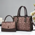 Detailed view of the elegant brown monogram tote bag set with premium texture and metal hardware. - Coffee
