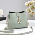Trendy light green bucket bag for women, stylish patterned shoulder bag with bow pendant. - Green