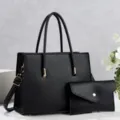 Detail view of black leather tote bag with matching pouch, premium texture, chic commuter style. - Black