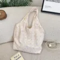 Close-up detail of the bow textured canvas shoulder bag in soft cream color aesthetic. - Pink