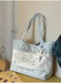 Close-up of canvas tote bag featuring delicate star embroidery, cute plush star pendant. - With Charm / Blue
