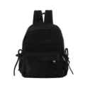 Detail view of black minimalist backpack with side bow decorations and front zipped pocket. - L / Black