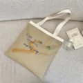 Canvas tote bag with inspirational English letter print, large capacity casual shoulder bag for daily use. - Shoulder Bag / Khaki Shoulder