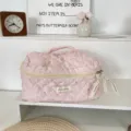 Pink quilted travel cosmetic bag with top handle, zipper closure, and cute pattern detail. - Pink Long-eared Character