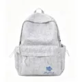 Grey nylon aesthetic backpack detail, featuring front zip pocket and blue flower embroidery. - Blue