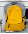 Vue détaillée du sac à dos scolaire jaune vif, modèle en toile décontracté de grande capacité. - Sans pendentif / Jaune