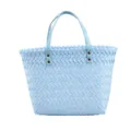 Detailed view of the light blue woven handbag, featuring delicate texture and sturdy handles. - Blue