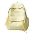 Close-up detail of light yellow student backpack featuring sparkling silver stars and tassel. - L / Yellow