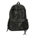 Detail shot of the black star print school backpack with front pocket and cute tassel charms. - L / Black