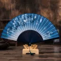 Traditional Chinese folding fan with blue floral pattern and elegant wooden display stand. - No. 3 Blue Butterfly Flower