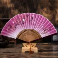 Traditional Chinese folding fan with purple gradient floral design, wooden carved ribs and stand. - No. 4 Wine Red Butterfly Flower