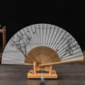 Vintage silk folding fan with bamboo frame and wooden display stand for elegant gift. - Brown Bone Gray Surface Bamboo / Gray