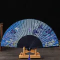 Traditional blue folding fan with floral and butterfly pattern, ideal for summer or props. - No. 9 Blue Ribs & Light Blue Face (Lily)