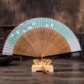 Elegant antique folding fan with cherry blossom pattern, wooden hollow carved ribs and stand. - No. 4 Green Cherry Blossom / Green