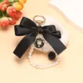Squisito ciondolo portachiavi con perle e fiocco nero, elegante accessorio per borsa. - Nero