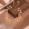 Detailaufnahme des eleganten rosa Suesswasserperlenarmbands mit feiner goldener Kette. - Rosa Perlenzweig Doppelschichtiges Armband