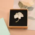 Ginkgo leaf brooch featuring sparkling cubic zirconia and an elegant white pearl accent pin. - Apricot Style