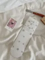 White mid-tube slouchy socks with blue floral lace trim, aesthetic style detail view. - White Vertical Stripes and Flowers