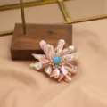 Elegant baroque pearl flower brooch with blue center stone and sparkling cubic zirconia. - Purple Long Pearl and Blue Stone Brooch