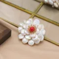 Elegant pearl flower brooch with red center, exquisite fashion jewelry accessory for women. - Three-Layer Pearl Brooch with Red Center Stone