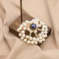 Handmade pearl brooch with dark center stone and white pearls in round floral design. - White Pearl Flower with Black Pearl Center Brooch