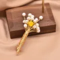 Elegant pearl flower brooch featuring wire-wrapped gold tone design and central yellow gem. - Yellow Pearl Bouquet Brooch