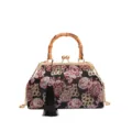 Detail shot of a vintage Chinese brocade floral handbag with bamboo handle and gold chain. - Black