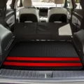 Detail view of anti-slip car trunk mat with red stripes, dirt-resistant cargo liner for SUV. - Red Striped / 100x75cm