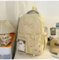 Beige student backpack detail view, transparent front pocket with cute toy, embroidery text. - No Pendant / Yellow