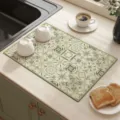Close-up of green retro tile pattern kitchen dish drying mat, absorbent surface detail. - Floating Light