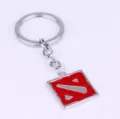 Detailed shot of metal DOTA keychain featuring a red square pendant with iconic game logo. - Charm / Silver