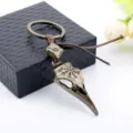 Macro view of vintage Viking crow skull keychain with Nordic runes and antique bronze finish - Bronze