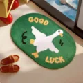 Green oval bath mat with white goose design and Good Luck text, faux cashmere texture - Animal Paradise-11