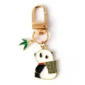 Close-up view of a cute panda enamel keychain with a green bamboo leaf charm accessory - G-1523 -1